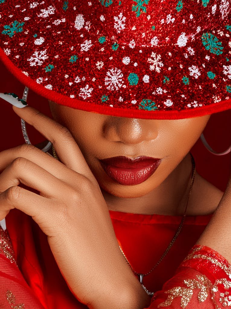 Close-up of a woman with red lipstick and a festive red hat. Fashion and style concept.