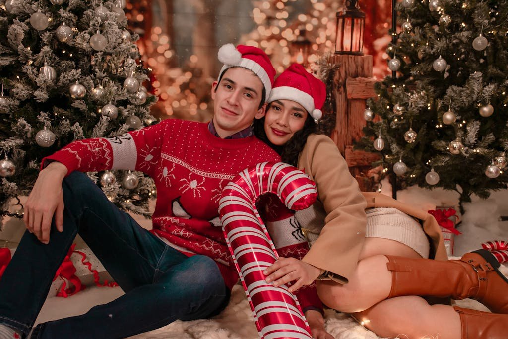 Romantic couple in Santa hats enjoying Christmas together with festive decorations