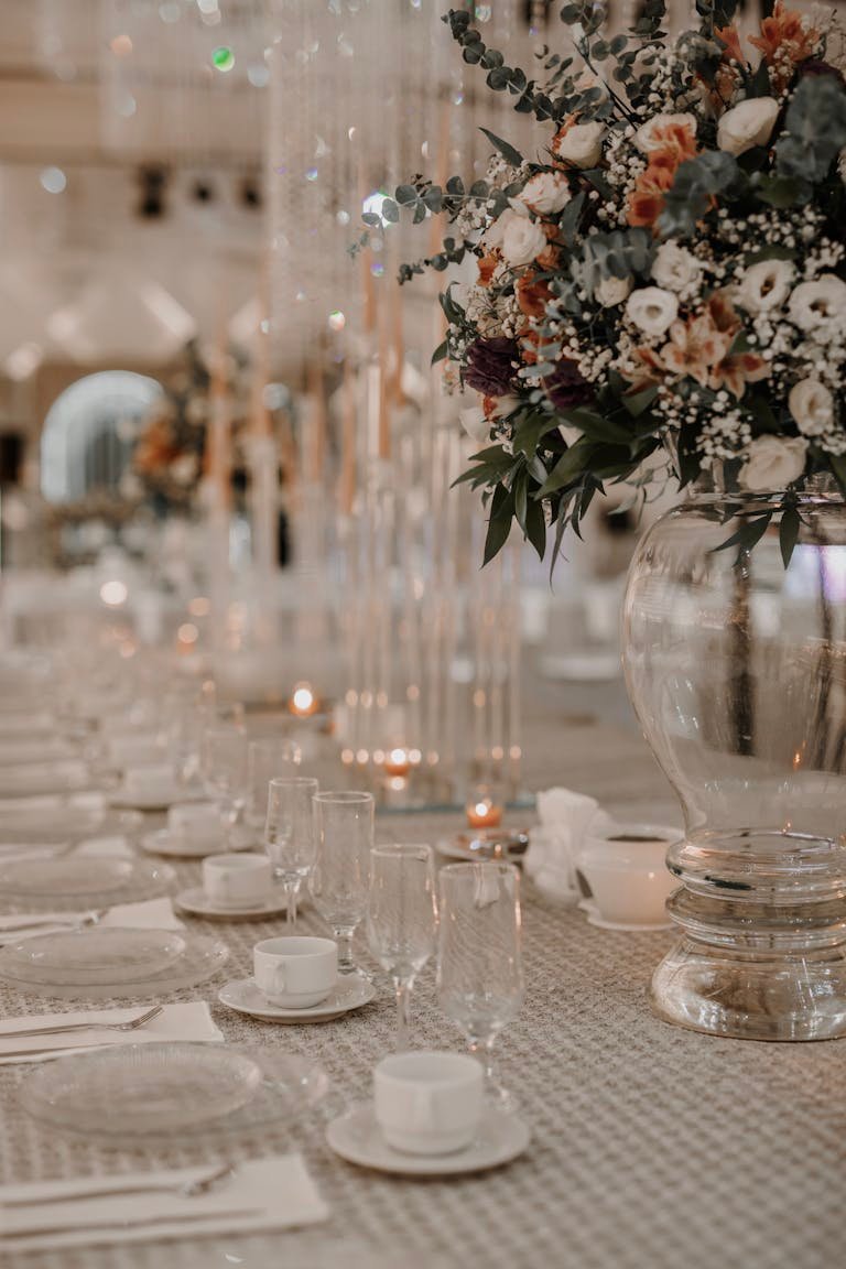 Luxurious wedding table with elegant floral decor and glassware indoors.