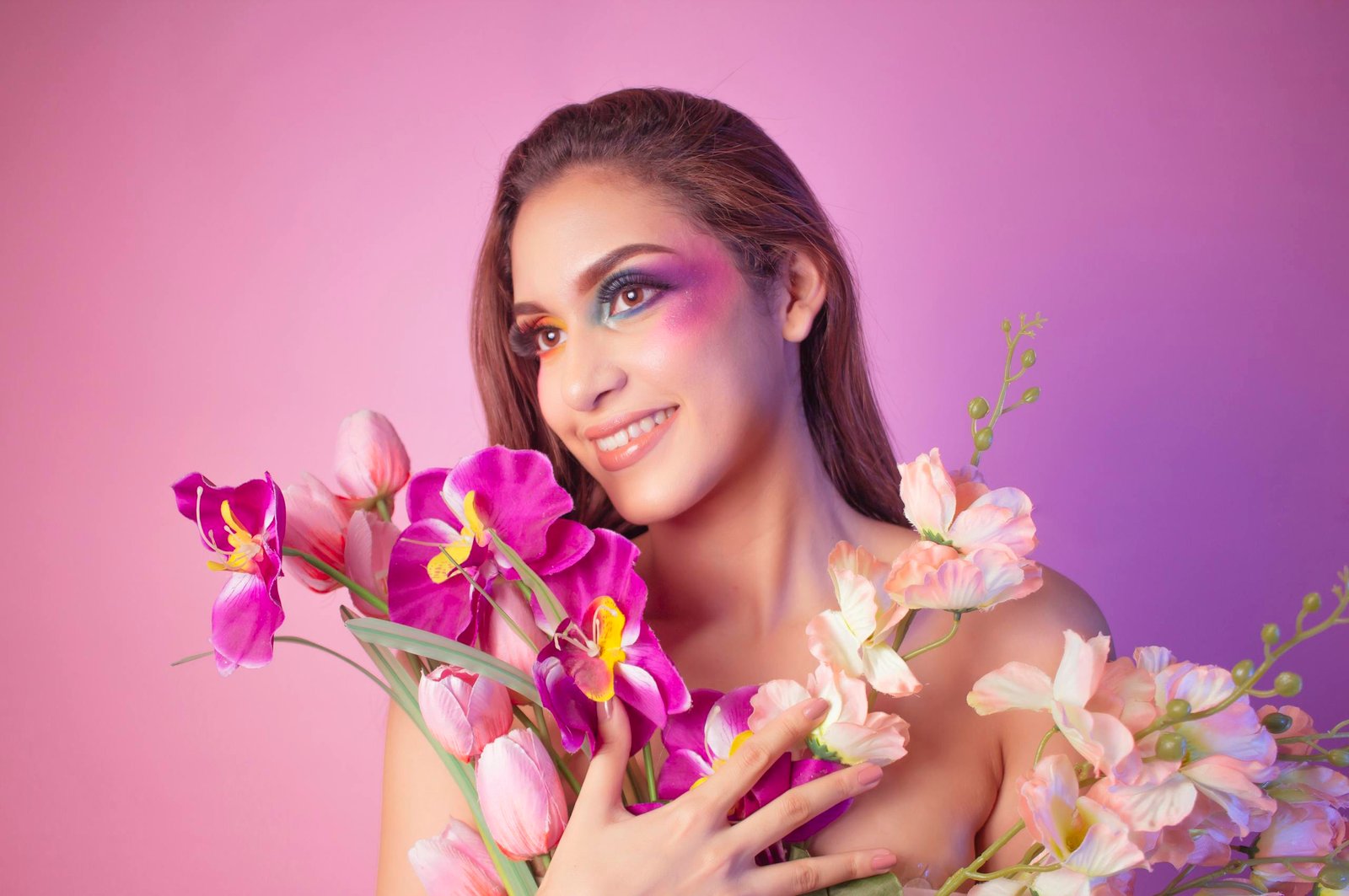 Spring 2026 makeup trends - woman with colorful spring makeup and flowers